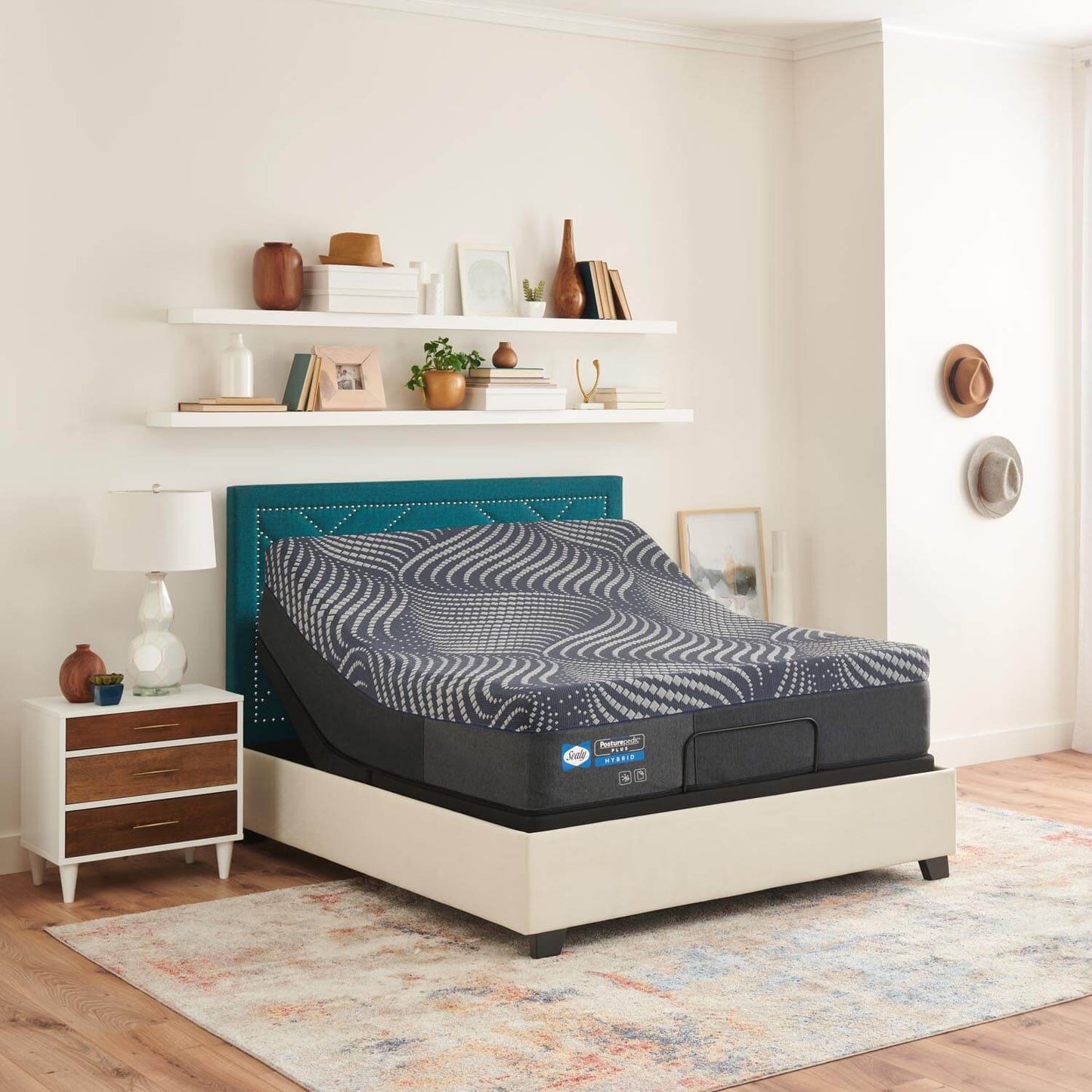 front angle of Sealy Posturepedic Plus Brenham Hybrid Soft Mattress flexing on an adjustable base