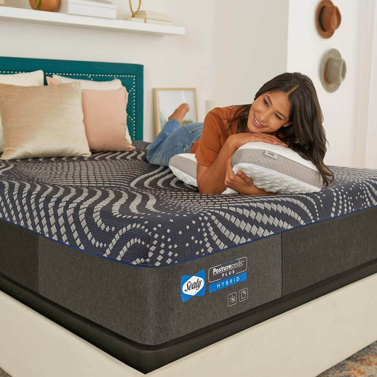 woman laying on Sealy Posturepedic Plus Albany Hybrid Medium Mattress 